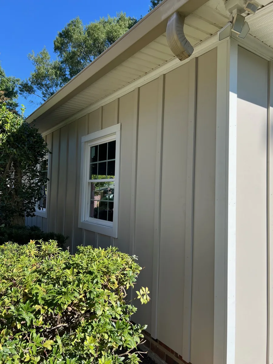 A white window in new board-and-batten siding